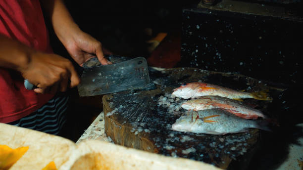 istock cutting fish with a knife into the Indonesian fish 1288126835