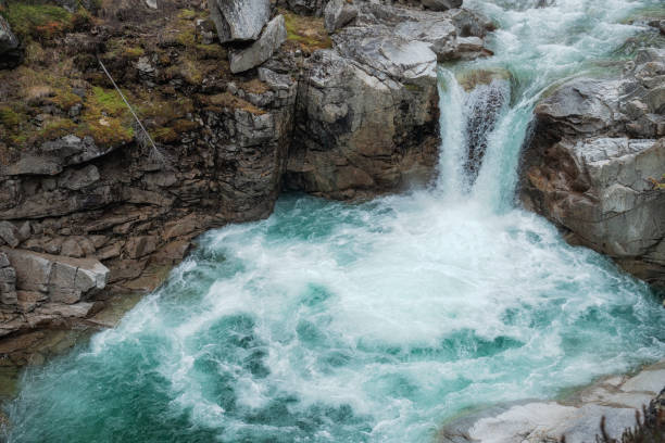 istock Waterfall mountain close up. Mountain river waterfall view. Waterfall river scene 1288127495