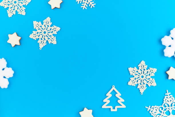 istock Flat layout of white decorative snowflakes and firtrees surrounding copyspace 1288128938