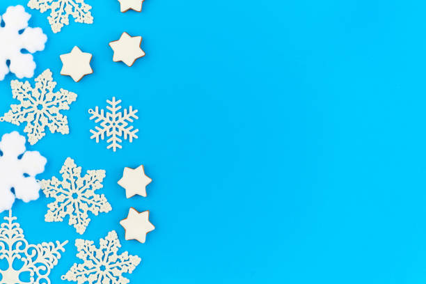 istock Flat layout of decorative snowflakes and firtrees with copyspace on the right 1288128942