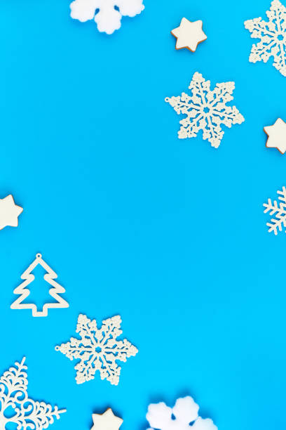 istock Flat layout of white snowflakes and firtrees surrounding copyspace for your text 1288128946