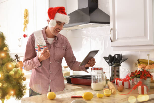 istock Man cooking consulting recipes on a tablet on christmas holidays 1288132609