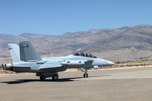 A legacy Boeing F/A-18 Hornet fighter jet sits on the ramp at KPNS before heading to Utah to get scrapped.