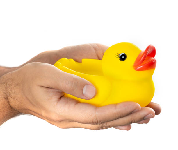 istock Yellow inflatable rubber duck in hands 1288135323