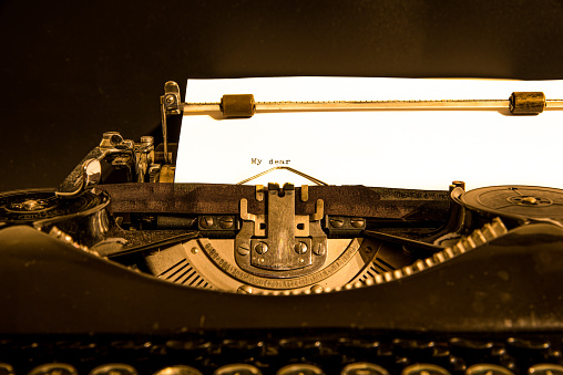 Antique typewriter showing traditional QWERTY keys. Before text messaging, people used typewriters to communicate by writing letters.