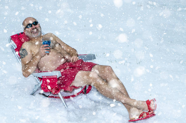 istock Man having a drink in swimming suit during winter 1288138439