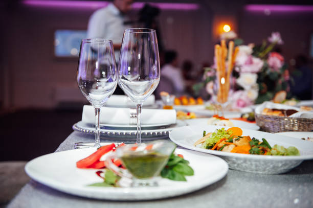 istock Luxurious restaurant. Luxurious interior, white tables, serving dishes and glasses for guests 1288139324