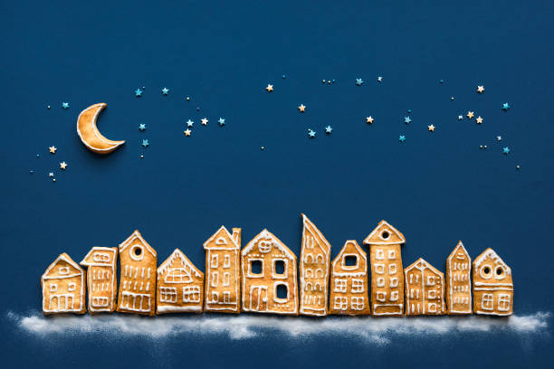 Christmas Cookies Village. Christmas landscape flat lay with Gingerbread cookies houses on dark blue background, top view, copy space.