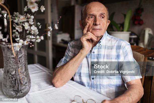Worried Senior Man Looking In Distance Stock Photo - Download Image Now - Dementia, Senior Adult, Worried