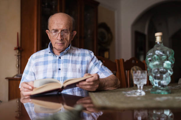 istock Man relaxing at home and reading a book 1288139558