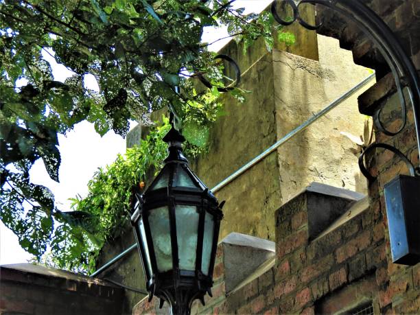 istock Medieval illuminated street lantern on a brick exterior wall. 1288143007