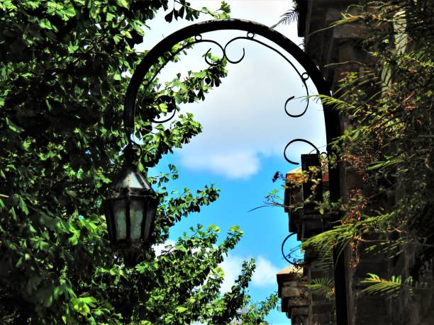 Medieval illuminated street lantern on a brick exterior wall en Recoleta , Buenos Aires ,Argentina.