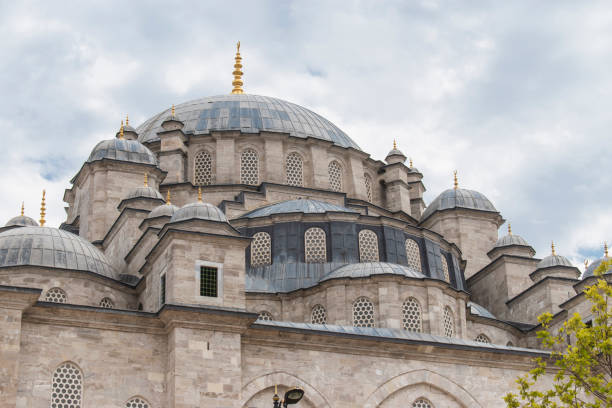 istock Fatih Mosque and Complex is a mosque and complex built by Fatih Sultan Mehmed in Fatih district of Istanbul. mosque with blue sky behind it. 1288143102