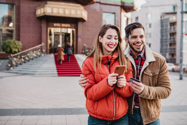 istock Young couple outdoors on a cold day using mobile phone 1288143438