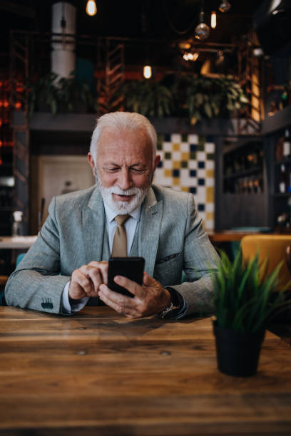 istock Senior businessman sitting in restaurant 1288145706