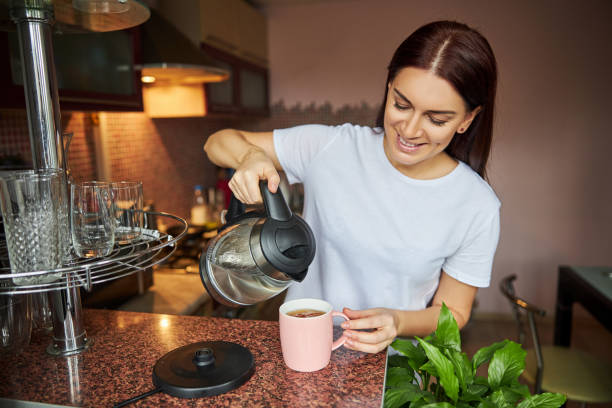 istock Woman adding more water to her tea 1288148334
