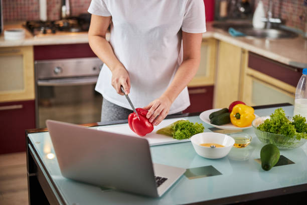 istock Female sticking her knife into a red pepper 1288148404