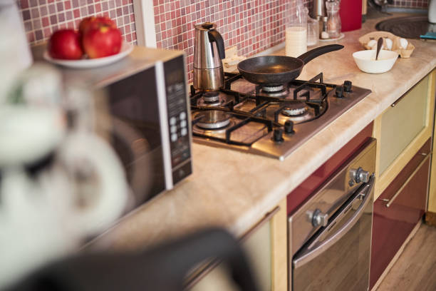 istock Frying pan and kettle standing on a cooker 1288148442
