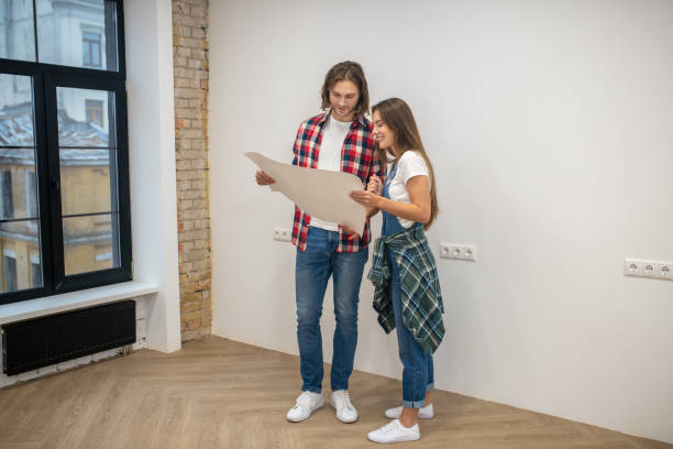 istock Young couple holding a design project and looking at it 1288148736
