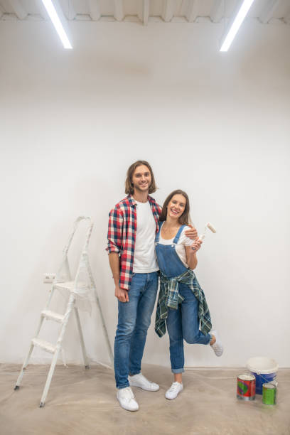istock Young couple standing near the white wall 1288148775