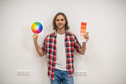 Color palette. Young man holding a color palette in hands
