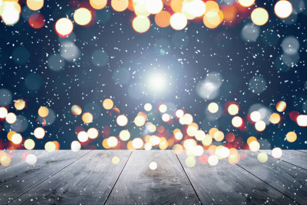 istock Abstract Snowy Christmas Background. Wooden Table With Defocused Lights 1288149819