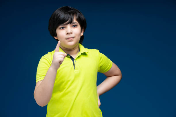 istock Boy at blue background - stock photo 1288152131