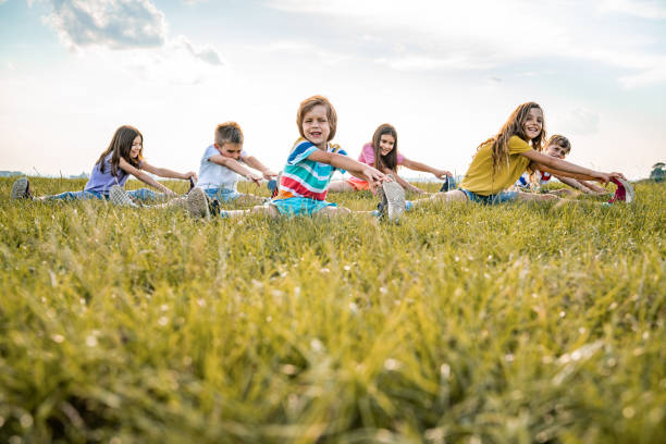 istock Group of kids stretching in nature 1288153528