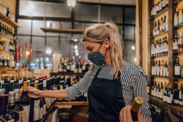 istock Woman working at a wine store during pandemic 1288156651