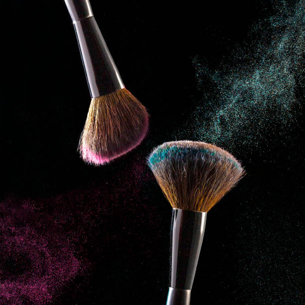 istock Makeup brushes, powder particles dynamically in the air. Spray cosmetics. Frozen dust, space simulation. 1288160170