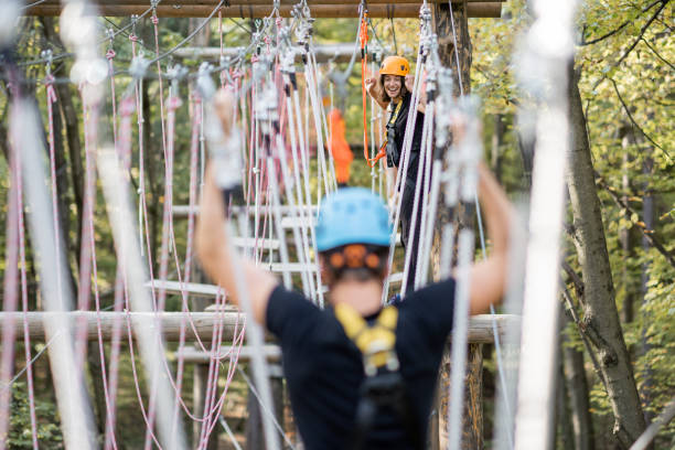 istock Man climbing ropes in a rope park 1288161708
