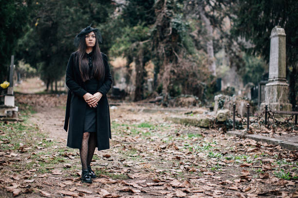 istock One sad young widow walking through cemetery 1288162222