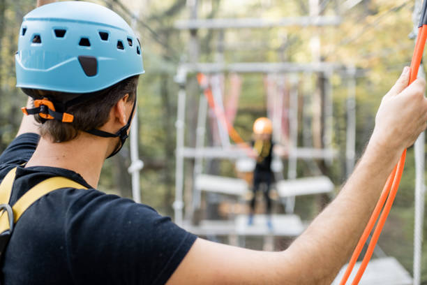 istock Man climbing ropes in a rope park 1288162292