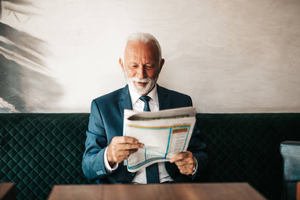 istock Senior business man at restaurant table 1288165841