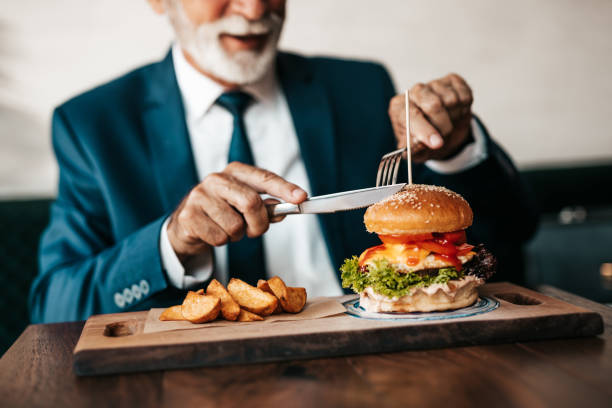 istock Senior businessman at restaurant table 1288165844
