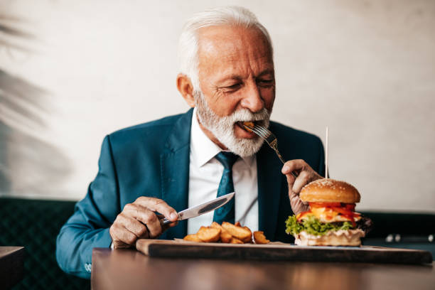 istock Senior businessman at restaurant table 1288165873