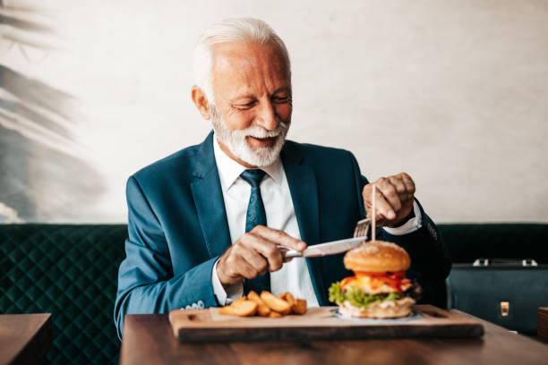 istock Senior businessman at restaurant table 1288165917