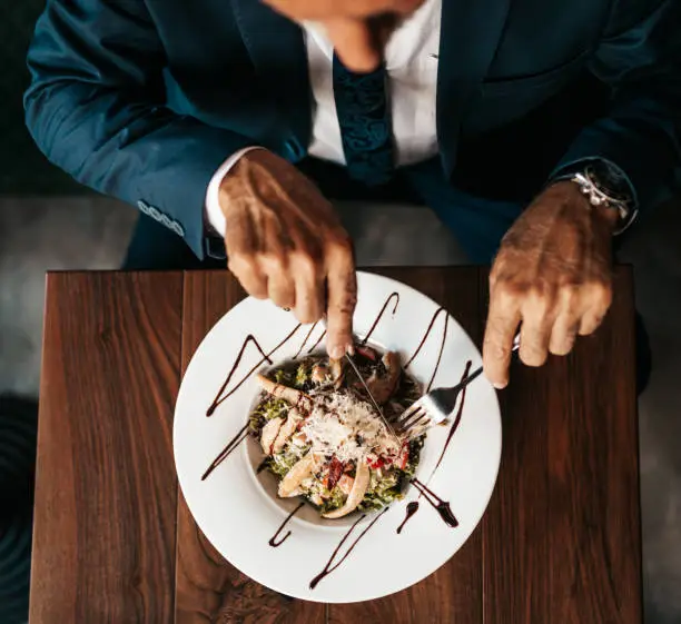 Photo of Senior businessman at restaurant table