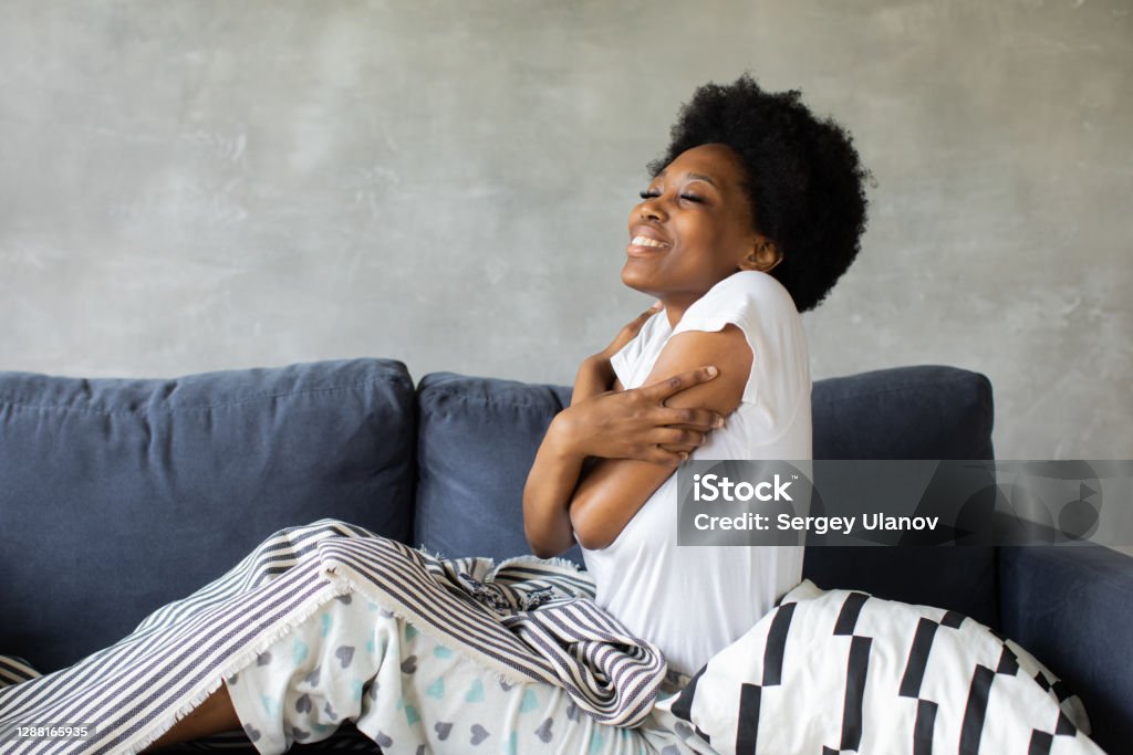 Happy african American young woman wakes up. Happy to move to new apartment. Happy african American young woman wakes up. Happy to move to new apartment. High quality photo Afro Hairstyle Stock Photo