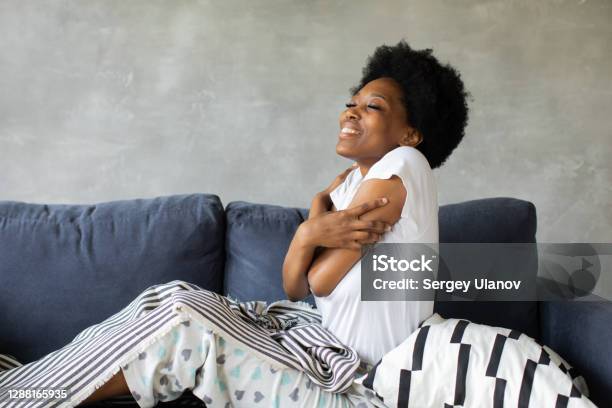 Happy African American Young Woman Wakes Up Happy To Move To New Apartment Stock Photo - Download Image Now