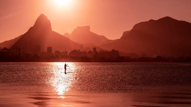 lagoa rodrigo de freitas w rio de janeiro z górami w tle i człowiekiem na wiosłach - brazil lagoa water sea zdjęcia i obrazy z banku zdjęć