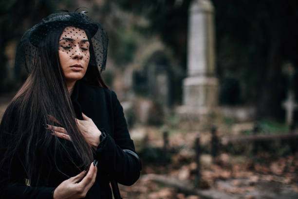 istock Sad widow visiting a loved one at the cemetery 1288167071