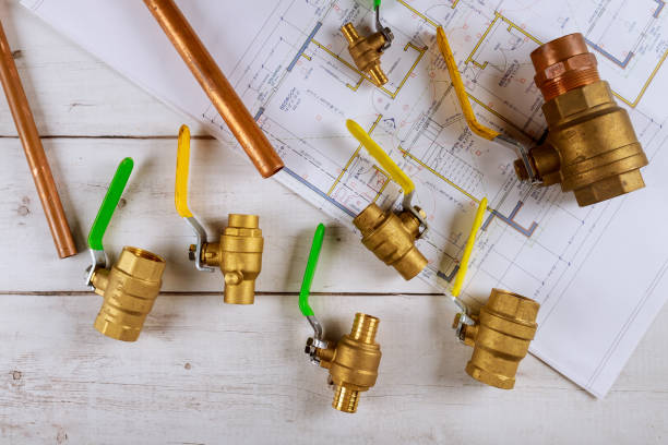 istock Set of brass plumbing fitting tools on wooden board 1288167312