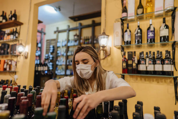 istock Woman working at a wine store during pandemic 1288168484