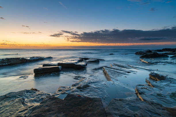istock Rocky coastline sunrise seascape 1288170195