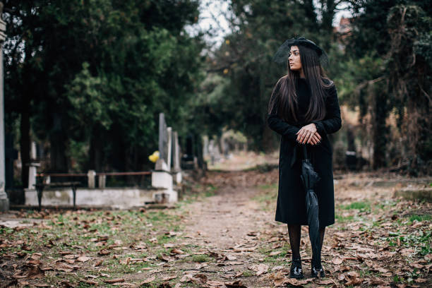 istock Young sad widow visiting a loved one at the cemetery 1288170372