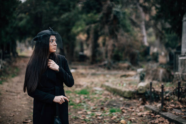 One young sad woman, widow, visiting a loved one at the cemetery.