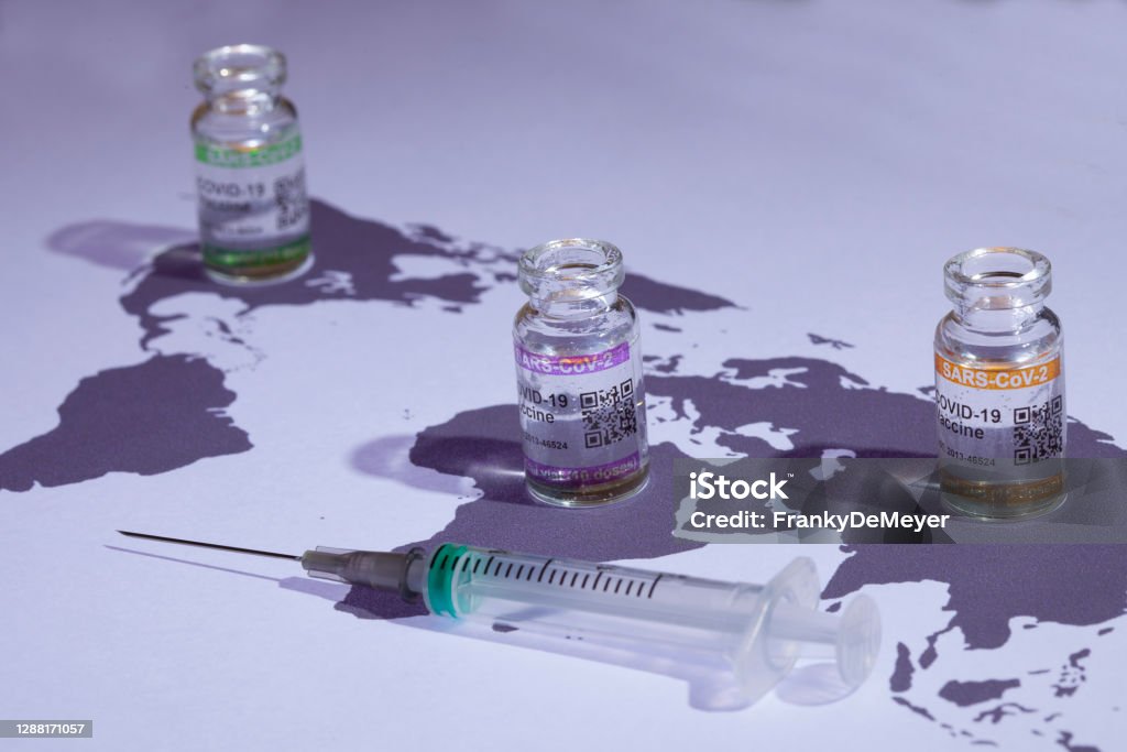 Coronavirus vaccine produced around the world in a race against time. Distribution of a vaccine. World map with COVID-19 (SARS-CoV-2) corona vaccine vials and injection syringe.

Notes:
- QR code on bottles was generated by my and contains generic text: "SARS-CoV-2 Vaccine""
- World map is in Public Domain: see: https://commons.wikimedia.org/wiki/File:BlankMap-World-noborders.png (author  E Pluribus Anthony has put it in public domain: see article in previous link) Vaccination Stock Photo