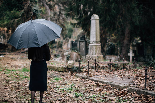 istock Woman visiting a loved one at the cemetery 1288171158