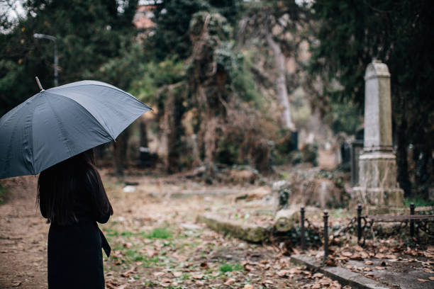 istock One woman visiting a loved one at the cemetery 1288171234